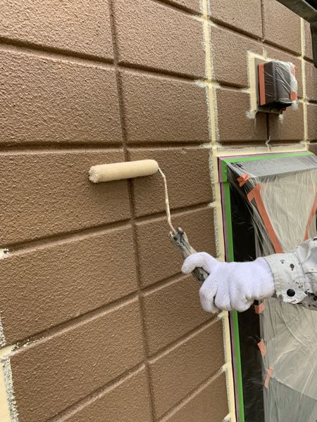外壁をシーラーで下塗りしています。